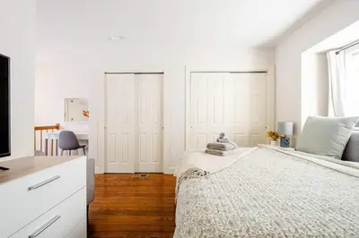 a white bedroom with a bed and a desk at Family Friendly Home in Trolley Square in Wilmington