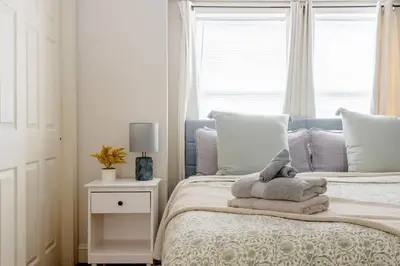 a bedroom with a bed with a stuffed animal on it at Family Friendly Home in Trolley Square in Wilmington
