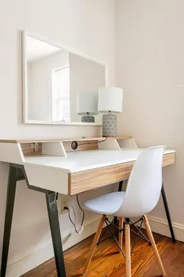 a desk with a mirror and a white chair at Family Friendly Home in Trolley Square in Wilmington