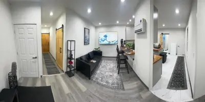 a living room with a couch and a kitchen at 2 bed luxe townhouse-condo NewYork 30 Min Away in Kearny