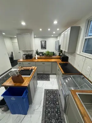 a kitchen with white cabinets and a counter top at 2 bed luxe townhouse-condo NewYork 30 Min Away in Kearny