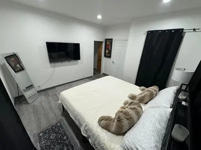 a bedroom with a bed with a teddy bear on it at 2 bed luxe townhouse-condo NewYork 30 Min Away in Kearny