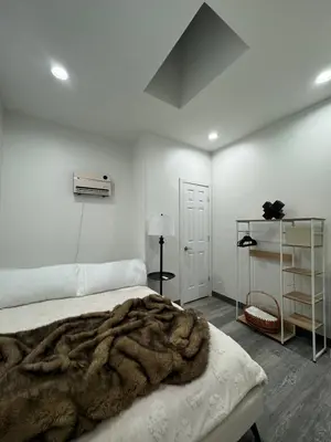 a bedroom with a bed with a blanket on it at 2 bed luxe townhouse-condo NewYork 30 Min Away in Kearny