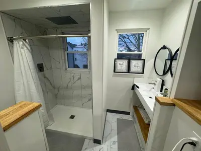 a bathroom with a shower and a sink at 2 bed luxe townhouse-condo NewYork 30 Min Away in Kearny