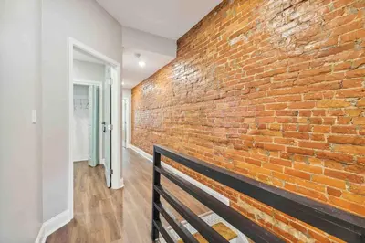 a brick wall with a bench in a hallway at 4BR Near HUP, CHOP, UPENN Free Parking 30 Days in Philadelphia