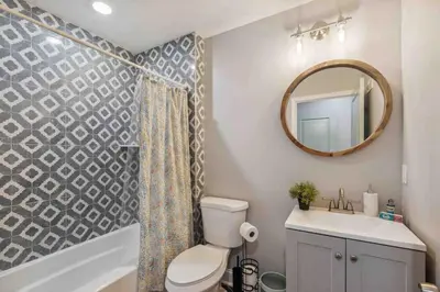 a bathroom with a toilet and a sink and a mirror at 4BR Near HUP, CHOP, UPENN Free Parking 30 Days in Philadelphia