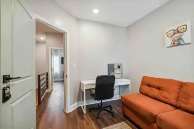 a living room with a couch and a desk at 4BR Near HUP, CHOP, UPENN Free Parking 30 Days in Philadelphia
