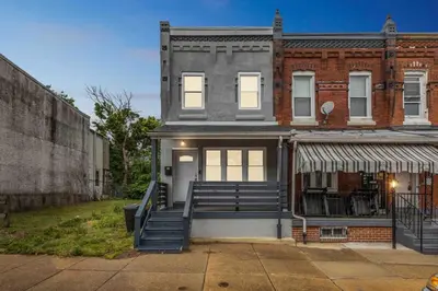 a brick building with a staircase in front of it at 4BR Near HUP, CHOP, UPENN Free Parking 30 Days in Philadelphia