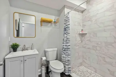 a bathroom with a toilet and a sink and a shower at 4BR Near HUP, CHOP, UPENN Free Parking 30 Days in Philadelphia