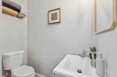 a bathroom with a white toilet and a sink at 4BR Near HUP, CHOP, UPENN Free Parking 30 Days in Philadelphia