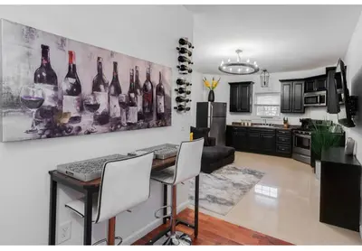 a kitchen with a table with wine bottles on the wall at Secür Your Vacation Home in Jersey City