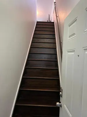 a stairway leading up to a white door at Secür Your Vacation Home in Jersey City