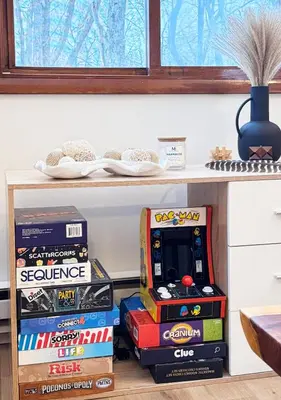 a shelf filled with boxes of video games at Blackwood Cabin Pocono in Pocono Farms East