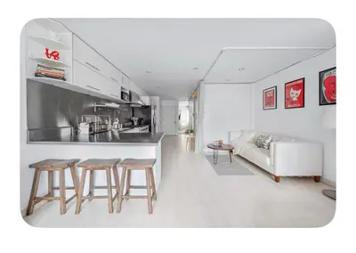 a kitchen and a living room with a couch and chairs at Bright and spacious apt, W&D in unit - Monthly in New York