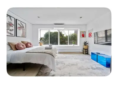 a bedroom with a large bed and a window at Bright and spacious apt, W&D in unit - Monthly in New York