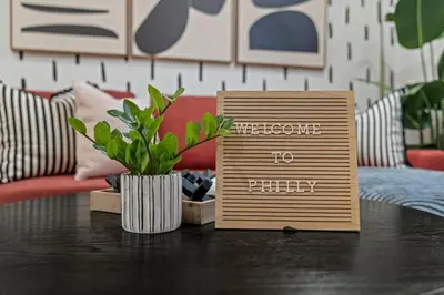 a table with a sign that reads welcome to party at Urban 1BR Apartment Near Center City & University City in Philadelphia
