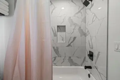 a bathroom with a shower with a shower curtain at Urban 1BR Apartment Near Center City & University City in Philadelphia