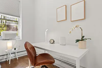 a white desk with a chair in a white room at Park Hamilton House 3B2B Modern Apt Mins to NYC in Jersey City