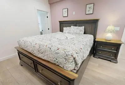 a bedroom with a bed and two night stands at 9 BR,34 Sleeps Skiing Lake Sauna Hottub Kayaks in Lake Harmony