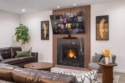 a living room with a couch and a fireplace at 9 BR,34 Sleeps Skiing Lake Sauna Hottub Kayaks in Lake Harmony