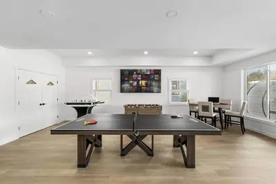 a ping pong table in a living room at 9 BR,34 Sleeps Skiing Lake Sauna Hottub Kayaks in Lake Harmony