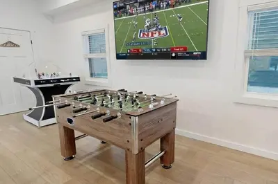 a game room with a foosball table at 9 BR,34 Sleeps Skiing Lake Sauna Hottub Kayaks in Lake Harmony