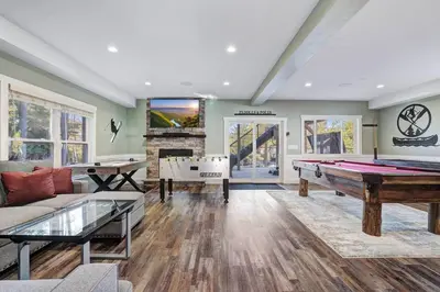a living room with a pool table and a couch at New Luxe! 9BR,7BA, Elevator, Sleeps 30, EV Charger in Lake Harmony