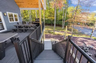 a porch with a picnic table and a grill at New Luxe! 9BR,7BA, Elevator, Sleeps 30, EV Charger in Lake Harmony