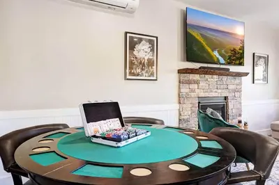 a room with a table with a laptop on it at New Luxe! 9BR,7BA, Elevator, Sleeps 30, EV Charger in Lake Harmony