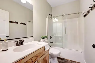 a bathroom with a sink and a shower and a toilet at New Luxe! 9BR,7BA, Elevator, Sleeps 30, EV Charger in Lake Harmony