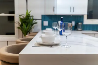 a kitchen counter with two wine glasses and a bowl at Pristine Pad, Sleep 9, Free driveway park, 20 PERCENT OFF in East Newark