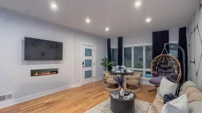 a living room with a couch and a fireplace at Pristine Pad, Sleep 9, Free driveway park, 20 PERCENT OFF in East Newark