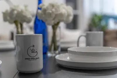 a coffee cup sitting next to a plate on a table at Pristine Pad, Sleep 9, Free driveway park, 20 PERCENT OFF in East Newark