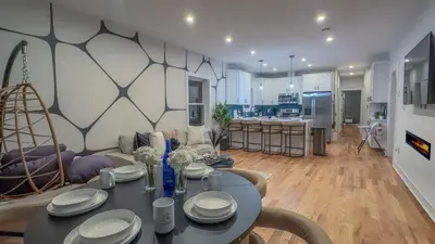 a living room with a table and a kitchen at Pristine Pad, Sleep 9, Free driveway park, 20 PERCENT OFF in East Newark
