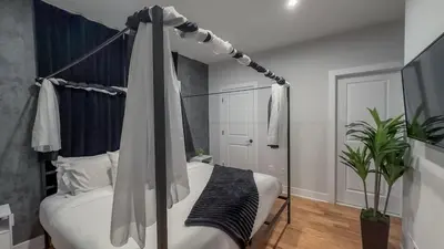 a bedroom with a canopy bed with a telescope at Pristine House, Sleep 21, Park 2 cars FREE, 20 PERCENT OFF in East Newark