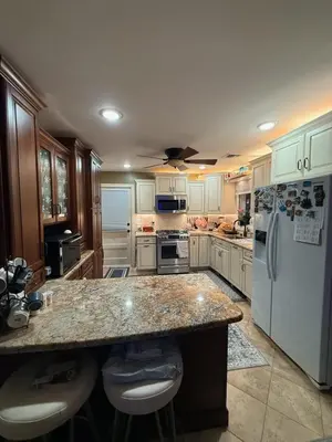 a kitchen with a large counter and a refrigerator at House For Rent Near MetLife Stadium in Hasbrouck Heights