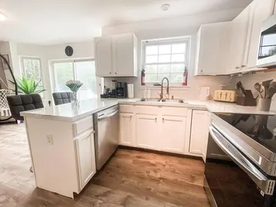 a kitchen with white cabinets and a sink at PrivatePool|Hot tub|Sauna|HomeTheater|Backyard in Long Pond