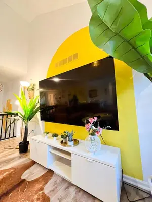 a living room with a large flat screen tv at PrivatePool|Hot tub|Sauna|HomeTheater|Backyard in Long Pond