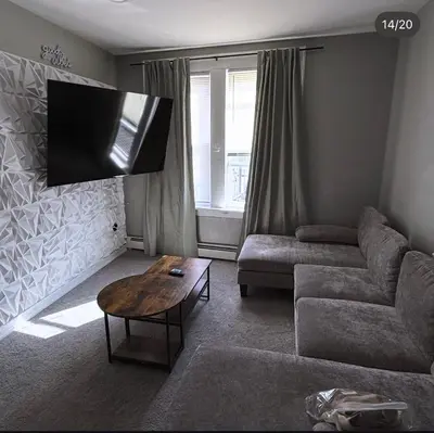 a living room with a couch and a table at EWRBNB - Rare Find! Huge 3BR Apartment with Open Layout minutes from Newark Airport & NYC - Apartment # 2 in Elizabeth