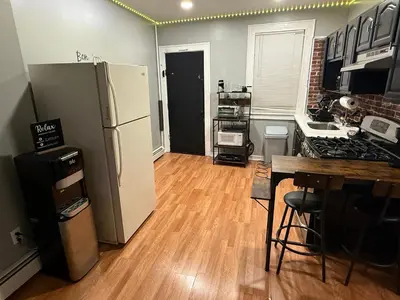 a kitchen with a refrigerator and a counter top at EWRBNB - Rare Find! Huge 3BR Apartment with Open Layout minutes from Newark Airport & NYC - Apartment # 2 in Elizabeth