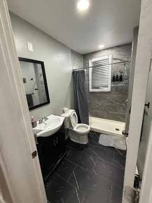 a bathroom with a sink and a toilet and a shower at EWRBNB - Rare Find! Huge 3BR Apartment with Open Layout minutes from Newark Airport & NYC - Apartment # 2 in Elizabeth