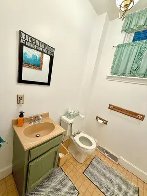 a bathroom with a toilet and a sink at Home away from home, Classic Victorian Haven in Harrisburg