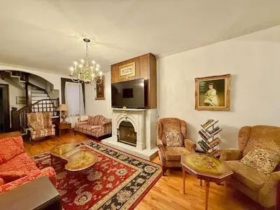 a living room with a couch and a fireplace at Home away from home, Classic Victorian Haven in Harrisburg