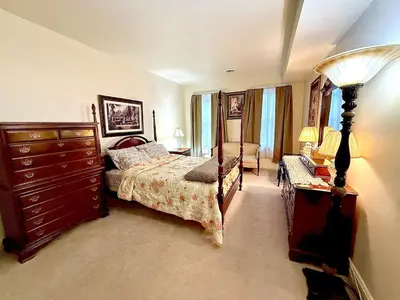 a bedroom with a bed and a dresser and a dresser at Home away from home, Classic Victorian Haven in Harrisburg