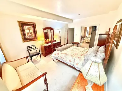 a bedroom with a bed and a couch and a chair at Home away from home, Classic Victorian Haven in Harrisburg