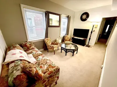 a living room with a couch and a table at Home away from home, Classic Victorian Haven in Harrisburg