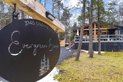 a sign in front of a house at Evergreen Escape Hot Tub Firepit Resort Pool in Thornhurst