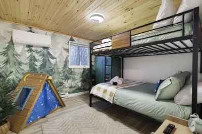 a bedroom with a bunk bed and a tree mural at Evergreen Escape Hot Tub Firepit Resort Pool in Thornhurst
