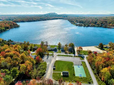 an aerial view of a lake with a park at Evergreen Escape Hot Tub Firepit Resort Pool in Thornhurst