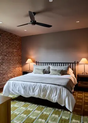 a bedroom with a large bed with a ceiling fan at Eleanor Inn - Suite Amelia in Warwick